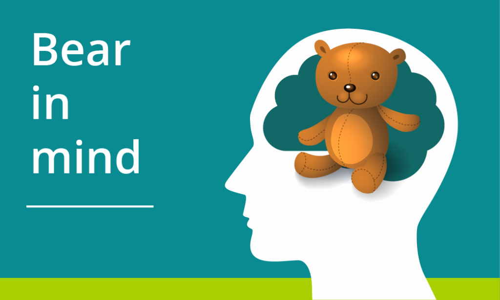 literal interpretation of the expression 'bear in mind' showing a small teddy bear sitting in the mind of a silhouette head.